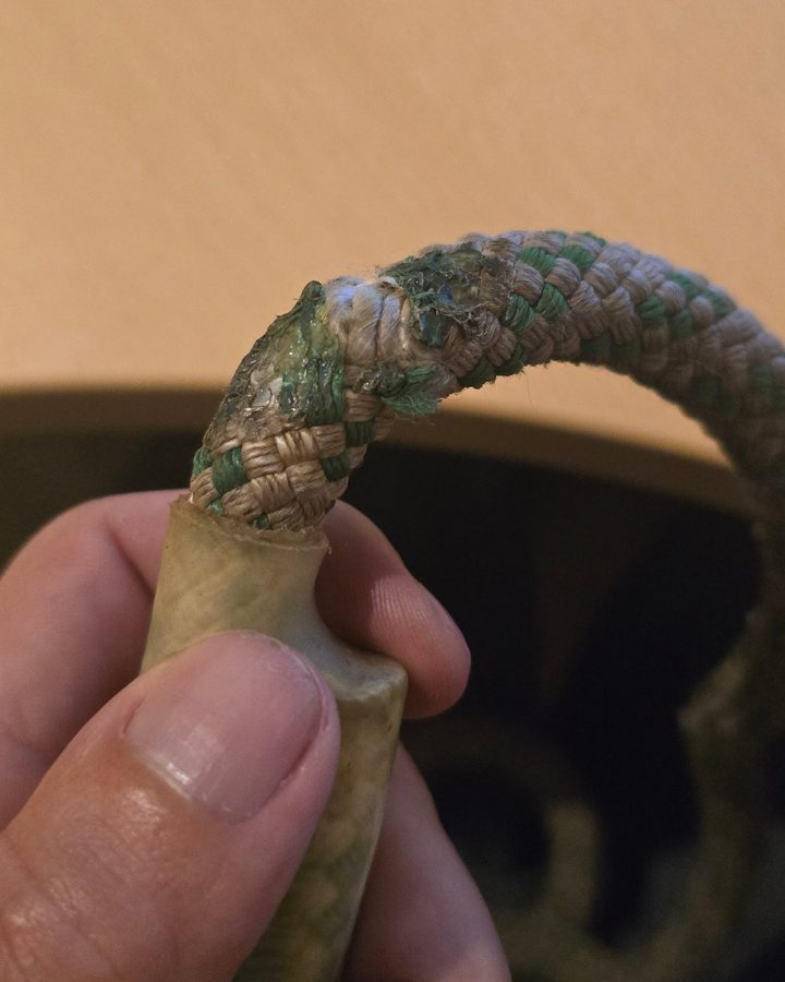 Braided climbing line with glazed, melted and torn sheath next to the termination
