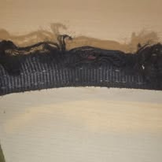 Black webbing with a badly frayed and cut edge